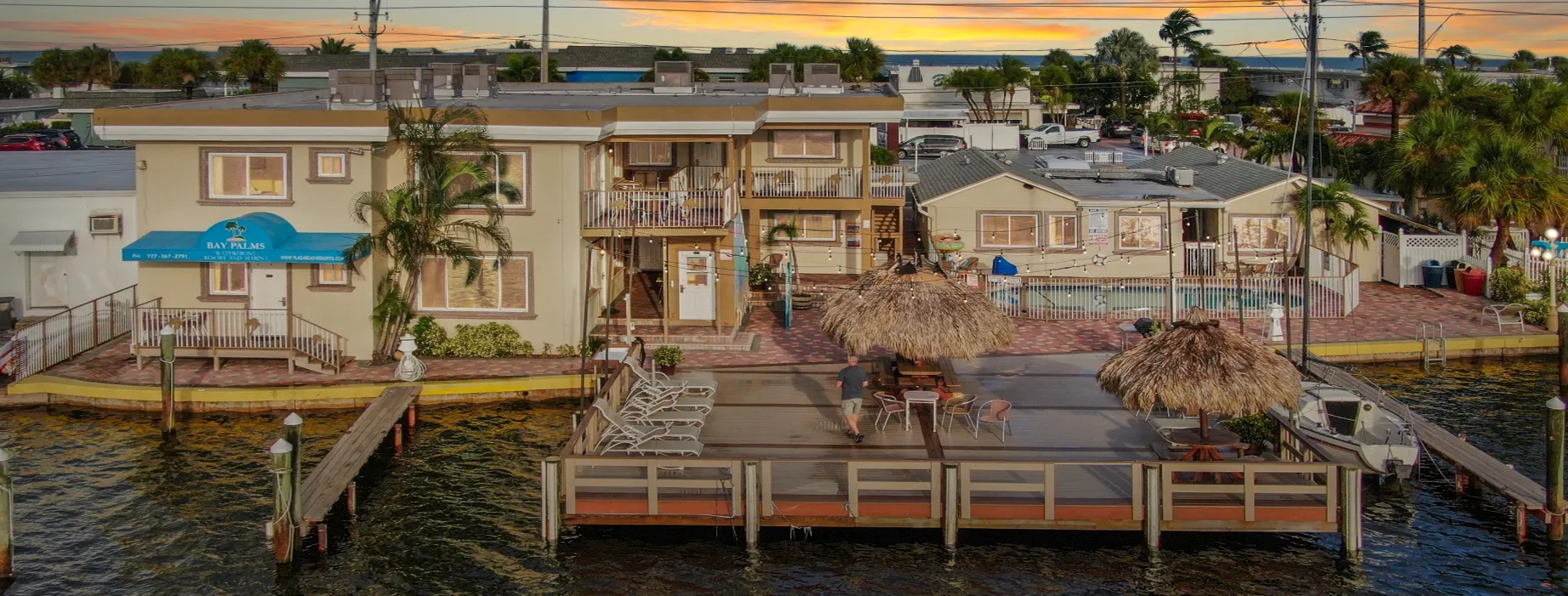 Beautiful waterfront view of Plaza Beach Resort St. Pete Beach with pool and palm trees